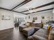 Inviting living room features a comfortable sectional sofa, hardwood floors, and decorative ceiling beams at 33 Travora Cir, York, SC 29745