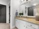 Stylish bathroom with granite countertops, white cabinets, and a decorative mirror at 604 Wisteria Walk Way, Fort Mill, SC 29715