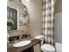 Bathroom featuring patterned shower curtain, granite countertops, and decorative mirror at 604 Wisteria Walk Way, Fort Mill, SC 29715