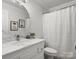 Bright bathroom features a modern vanity with marble countertop and framed circular mirror at 604 Wisteria Walk Way, Fort Mill, SC 29715