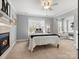 Comfortable bedroom features a decorative fireplace, large window, and cozy decor at 604 Wisteria Walk Way, Fort Mill, SC 29715