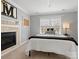 Inviting bedroom featuring a fireplace, plush carpet, and natural light from a large window at 604 Wisteria Walk Way, Fort Mill, SC 29715