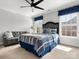 Inviting bedroom with a ceiling fan, large window, stylish bedding, and a comfortable sitting area at 604 Wisteria Walk Way, Fort Mill, SC 29715