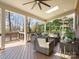 Relaxing covered porch with wicker furniture, a stone fire pit and tranquil wooded views at 604 Wisteria Walk Way, Fort Mill, SC 29715