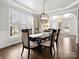 Elegant dining room featuring hardwood floors, modern lighting, and large windows at 604 Wisteria Walk Way, Fort Mill, SC 29715