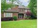 Charming two-story brick home with manicured lawn and mature trees and landscaping at 604 Wisteria Walk Way, Fort Mill, SC 29715