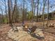 Outdoor fire pit area with seating, surrounded by trees, perfect for relaxing at 604 Wisteria Walk Way, Fort Mill, SC 29715