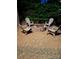 Outdoor fire pit with lots of adirondack chairs under the night sky, perfect for gathering with friends at 604 Wisteria Walk Way, Fort Mill, SC 29715