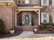 Charming brick home with welcoming front porch, tasteful landscaping, and decorative wreath at 604 Wisteria Walk Way, Fort Mill, SC 29715