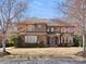 Charming two-story brick home with mature landscaping and inviting front porch at 604 Wisteria Walk Way, Fort Mill, SC 29715