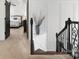 Hallway with wrought iron railing leading to the main bedroom, featuring light walls and carpet flooring at 604 Wisteria Walk Way, Fort Mill, SC 29715