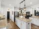 Stylish kitchen features stainless steel appliances, granite countertops and white cabinetry at 604 Wisteria Walk Way, Fort Mill, SC 29715