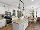 Modern kitchen with granite countertops, stainless steel appliances, and ample storage at 604 Wisteria Walk Way, Fort Mill, SC 29715