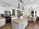 Gourmet kitchen featuring granite countertops, an island with bar seating, and stainless steel appliances at 604 Wisteria Walk Way, Fort Mill, SC 29715