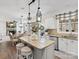 Bright kitchen features granite countertops, stainless steel appliances, and an island with barstool seating at 604 Wisteria Walk Way, Fort Mill, SC 29715