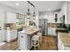 Modern kitchen featuring stainless steel appliances, white cabinets, and a granite island with seating at 604 Wisteria Walk Way, Fort Mill, SC 29715