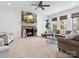 Bright living room with a stone fireplace, large windows, and comfortable seating at 604 Wisteria Walk Way, Fort Mill, SC 29715