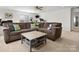 Spacious carpeted living room featuring a large sectional sofa and coffee table with storage at 604 Wisteria Walk Way, Fort Mill, SC 29715
