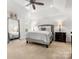 Bright and airy main bedroom with a trey ceiling, neutral tones, plush carpet, and lots of natural light at 604 Wisteria Walk Way, Fort Mill, SC 29715