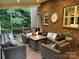 Covered porch area with cozy seating, a fire pit table, and stylish decor, perfect for relaxing outdoors at 604 Wisteria Walk Way, Fort Mill, SC 29715