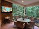 Outdoor covered deck with a grill, a dining table, and a view of the surrounding greenery, perfect for entertaining at 604 Wisteria Walk Way, Fort Mill, SC 29715