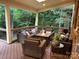 Inviting covered porch with comfortable seating, a fire pit, and a view of lush greenery at 604 Wisteria Walk Way, Fort Mill, SC 29715