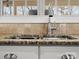 Close up of granite countertops, stainless steel sink, and tile backsplash at 604 Wisteria Walk Way, Fort Mill, SC 29715