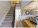 Inviting foyer with staircase leading to a dining room featuring elegant décor and stylish furnishings at 7020 Butternut Oak Ter, Huntersville, NC 28214