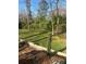 Green backyard featuring a retaining wall, landscaping, and partial shade from mature trees at 7144 Hunters Bluff Dr, Denver, NC 28037