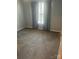 Neutral carpeted bedroom featuring a window with bright natural light and curtains at 7144 Hunters Bluff Dr, Denver, NC 28037