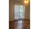 Bedroom with wood flooring and large window providing natural light and views of the outdoors at 7144 Hunters Bluff Dr, Denver, NC 28037