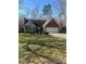 Charming brick and siding home with attached garage and well-manicured lawn and landscaping at 7144 Hunters Bluff Dr, Denver, NC 28037