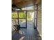 A screened-in porch with wooden flooring, offering an outdoor space with protection at 7144 Hunters Bluff Dr, Denver, NC 28037