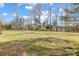 Picturesque view of the expansive and grassy backyard surrounded by mature trees at 737 Sanside Dr, York, SC 29745