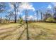 Large and well-maintained grassy backyard surrounded by beautiful mature trees at 737 Sanside Dr, York, SC 29745