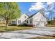 Side view of a charming white home with an attached garage and well-maintained landscaping at 737 Sanside Dr, York, SC 29745