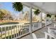 Cozy porch area with white railings, ferns hanging, and beautiful yard at 737 Sanside Dr, York, SC 29745