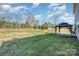 Expansive backyard features a gazebo and lush green lawn, great for entertaining at 887 Pointe Andrews Dr, Concord, NC 28025