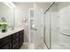 Bathroom featuring a double sink vanity, glass shower and view to bedroom; great natural light at 887 Pointe Andrews Dr, Concord, NC 28025