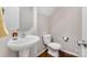 Half bathroom features a pedestal sink and wood floors at 887 Pointe Andrews Dr, Concord, NC 28025