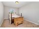 Bright bedroom with wooden bed and carpeted floor; a cozy and inviting space at 887 Pointe Andrews Dr, Concord, NC 28025