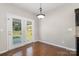 Bright dining area features hardwood floors and access to the backyard at 887 Pointe Andrews Dr, Concord, NC 28025