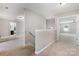 Upstairs hallway showcasing neutral tones and plush carpeting leading to bedrooms and bathroom at 887 Pointe Andrews Dr, Concord, NC 28025