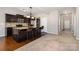 Kitchen with granite island, dark wood cabinets, open layout to living spaces at 887 Pointe Andrews Dr, Concord, NC 28025