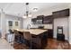 Kitchen featuring a center island with granite countertops and dark wood cabinetry, adjacent to backyard access at 887 Pointe Andrews Dr, Concord, NC 28025