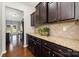 Kitchen with granite countertop, dark wood cabinets, and ceramic tile backsplash at 887 Pointe Andrews Dr, Concord, NC 28025