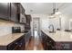 Well-equipped kitchen with dark wood cabinets, granite countertops, and stainless steel appliances at 887 Pointe Andrews Dr, Concord, NC 28025