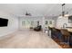 Spacious living room with carpet, a ceiling fan, and flows into the kitchen at 887 Pointe Andrews Dr, Concord, NC 28025