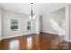 Bright living room featuring hardwood floors, neutral paint, and large windows for ample natural light at 887 Pointe Andrews Dr, Concord, NC 28025