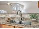 Granite countertops and stainless steel sink add beauty to this kitchen at 974 Platinum Dr, Fort Mill, SC 29708